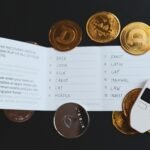 a cell phone sitting on top of a pile of coins